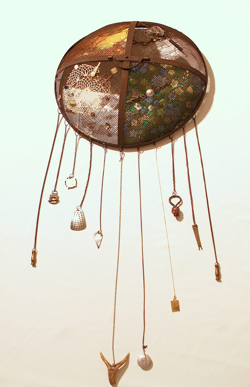 Tortoise Shield- , metal brazier screen, wallpaper, vinyl, various chains, vintage cuff links, various metal findings, bottle opener, horn, cotton doily, button, electric shaver head, spring, 20x45”
